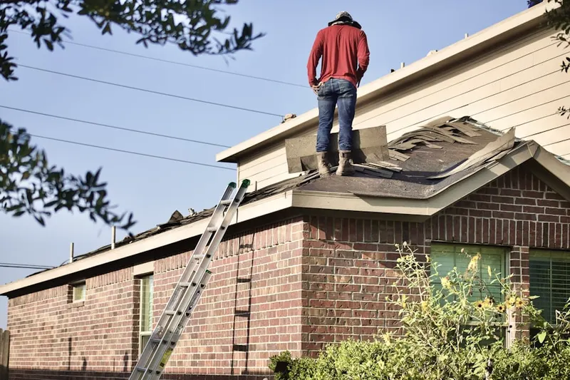 Professional roofer working on a residential roof in Richardson Ranch